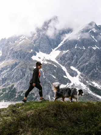dog oslo with his owner in the mountains